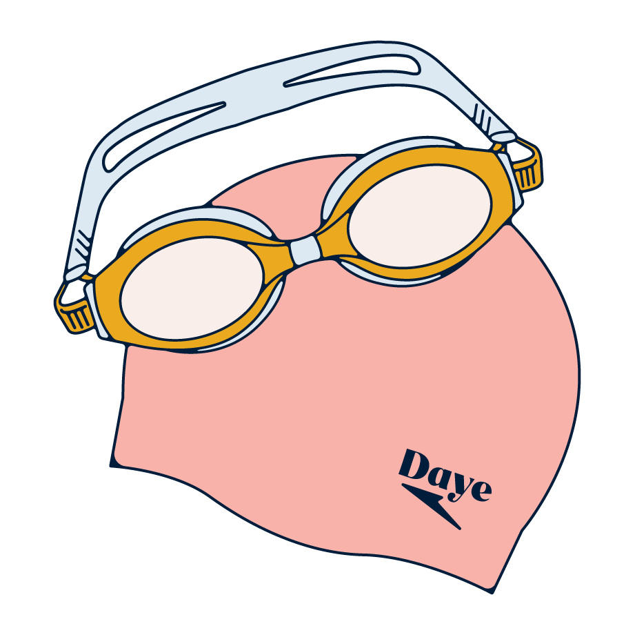 Swimming goggles next to a swimming hat.