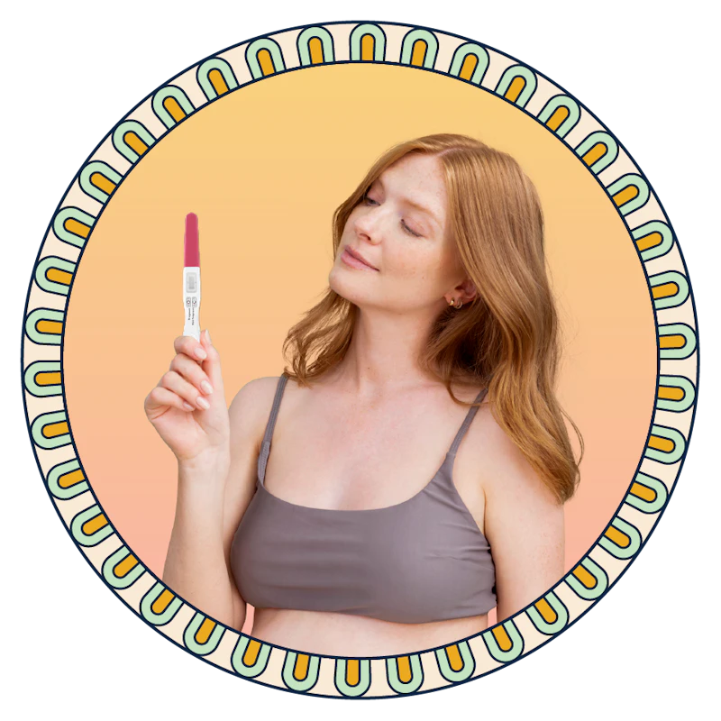 A person holding a pregnancy test.