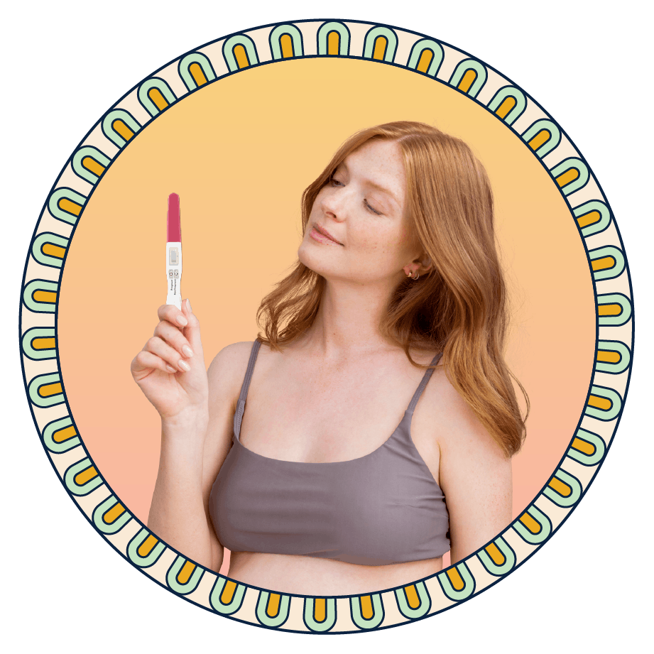 A person holding a pregnancy test.
