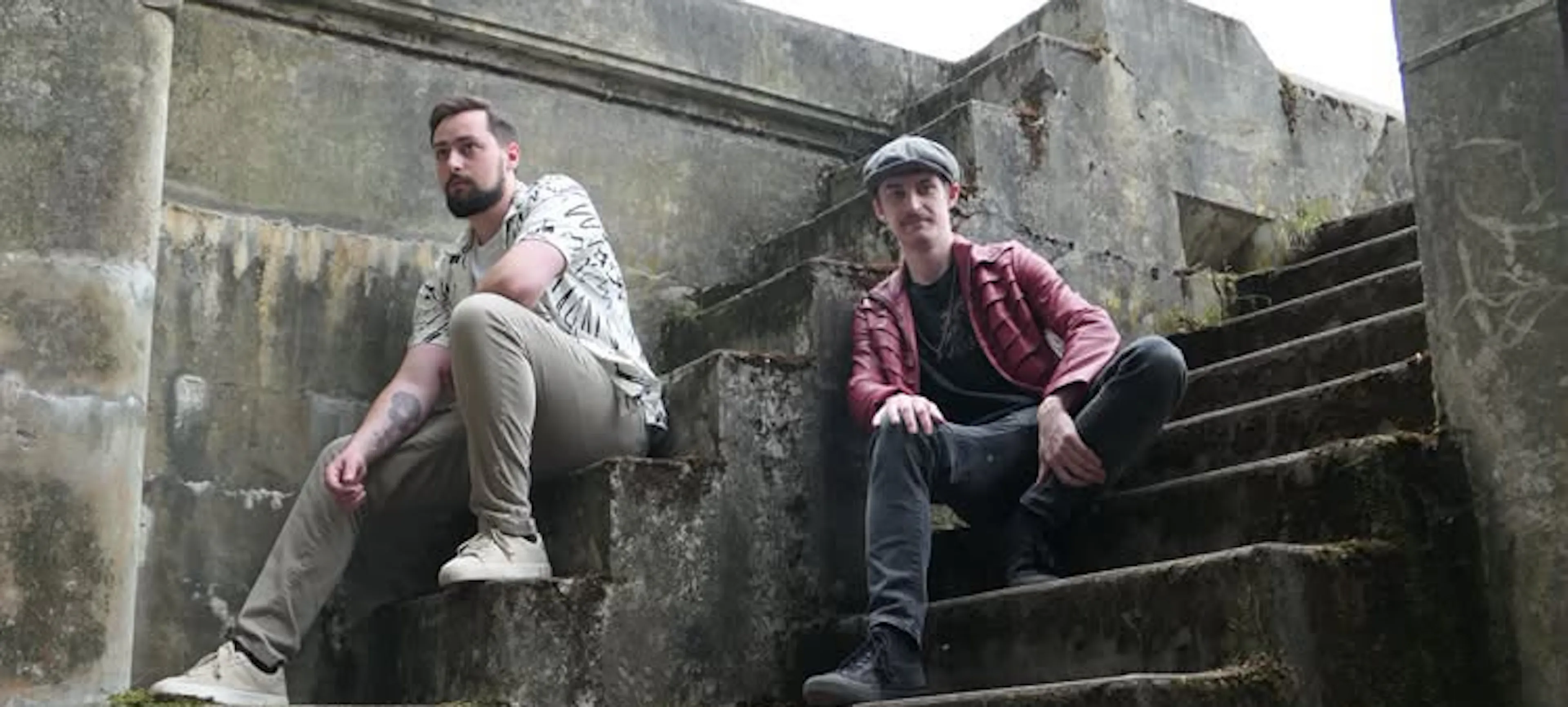 Luke and friend sitting on stairs