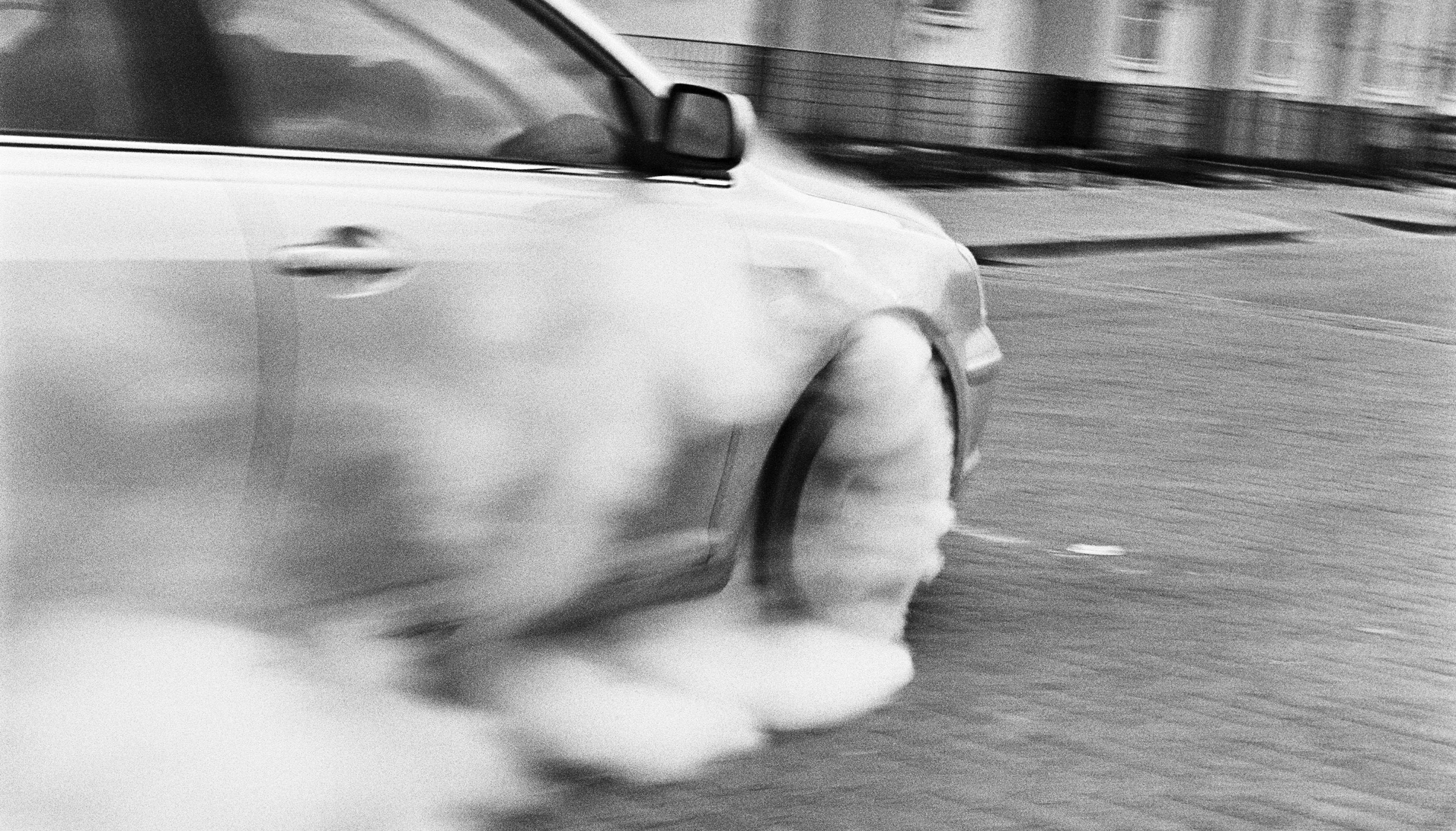 Another photograph from Ross McDonnell's new book Joyrider, picturing a car's tires smoking.