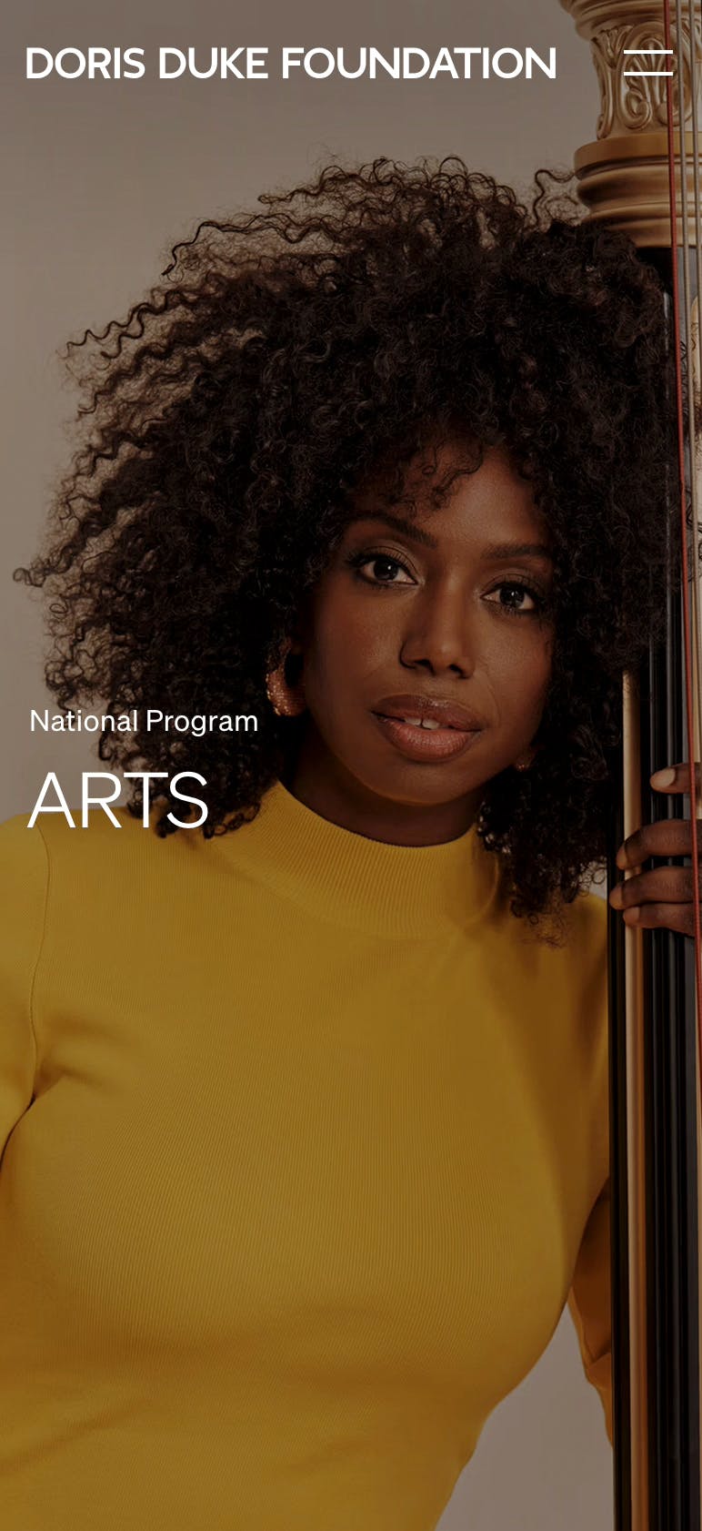 Full-bleed image a of a woman leaning on a musical instrument with the title "Arts" on top.