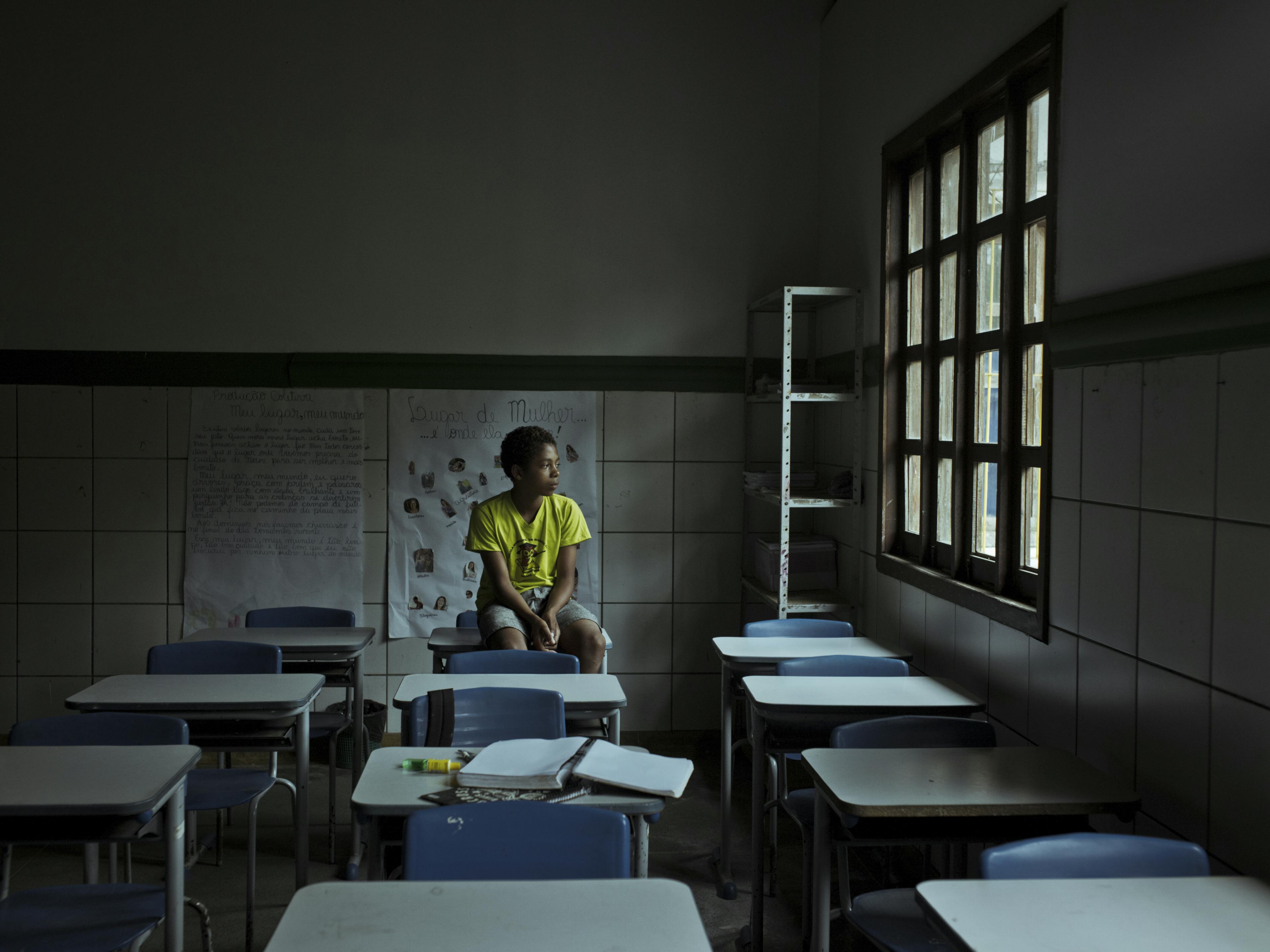 Caio sits in a classroom at his school in Itacaré, Brazil. Photography by Cristina de Middel.