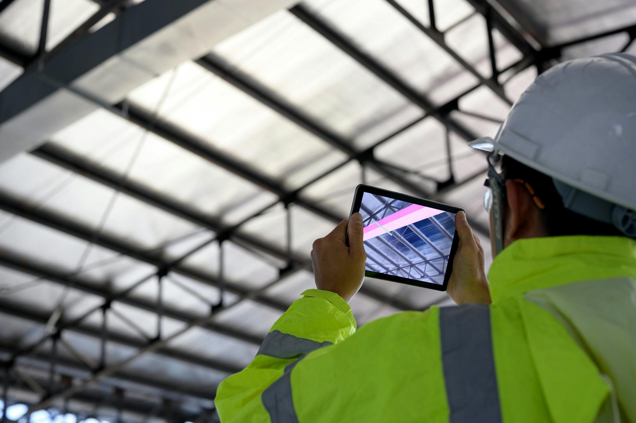 Field techinician taking a picture with his tablet