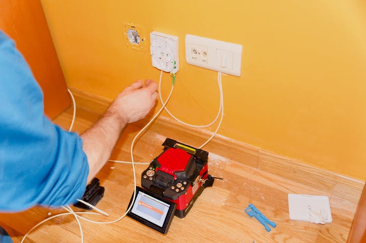 a technician connects a fiber termination point