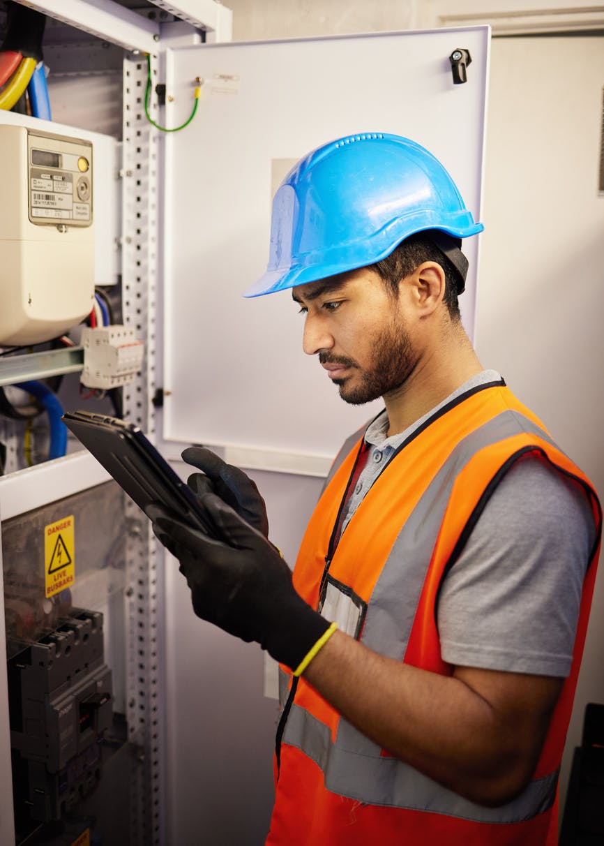 Technician using a tablet in front of a network asset