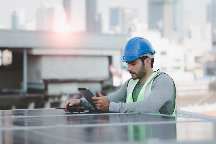 field technician looking at his tablet to confirm if installation was properly conducted.