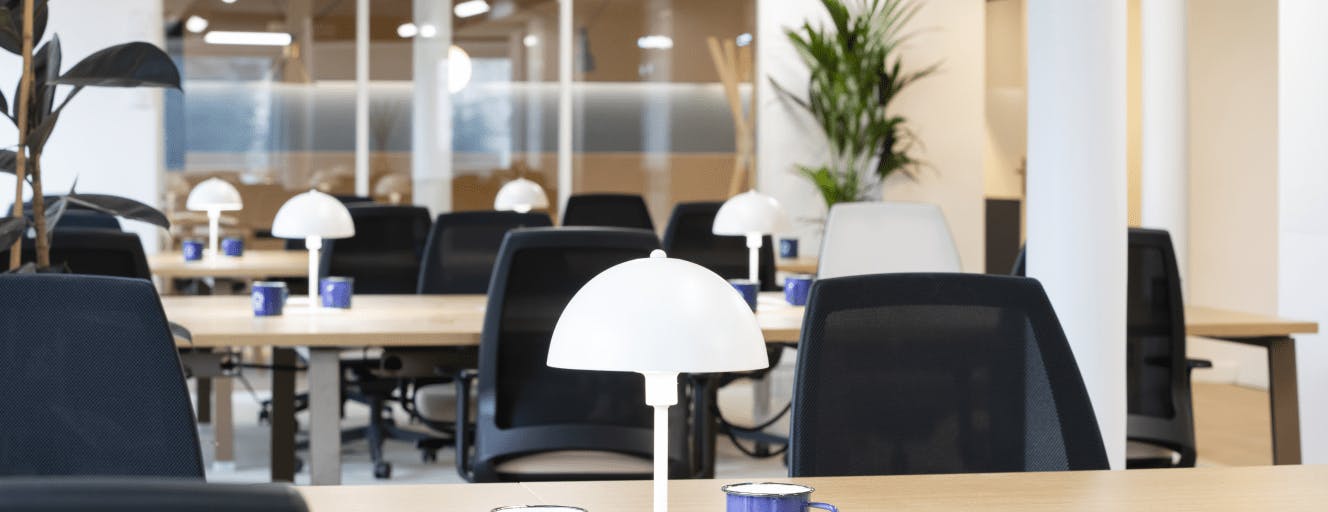 Black office chairs and wooden work tables inside Deepomatic's office in the 3e Arrondisement of Paris 