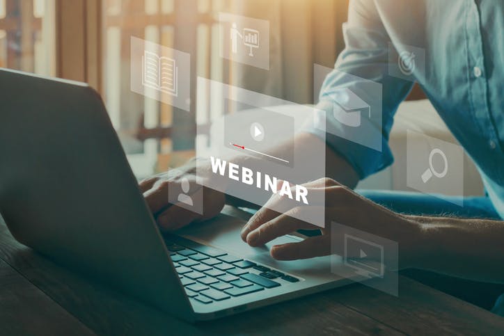 Person, die einen Computer benutzt, um eine Webinar-Seite zu laden
