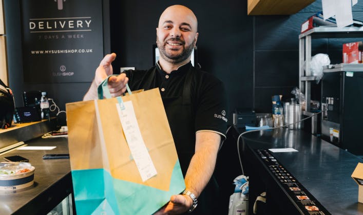 Deliveroo partner holding a delivery bag