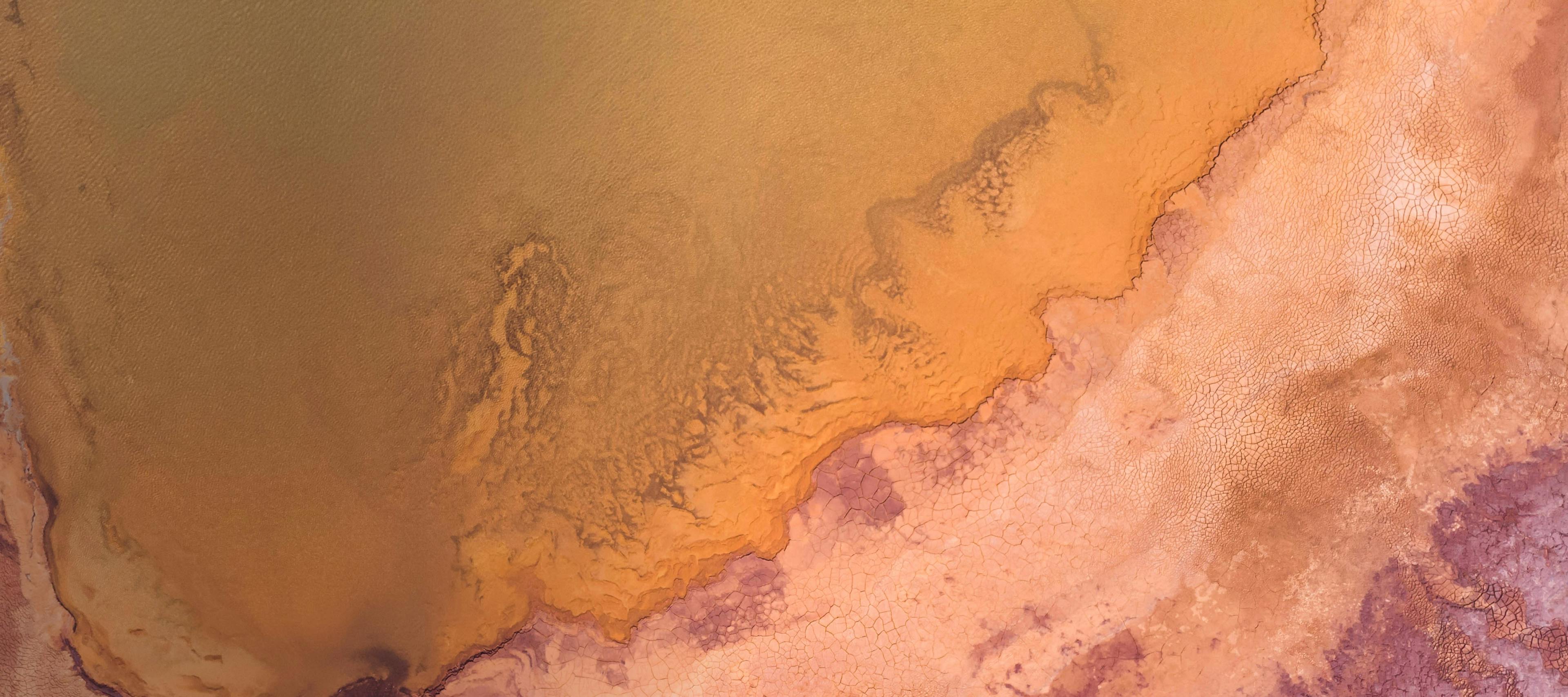 Aerial view of abstract pink and orange land.