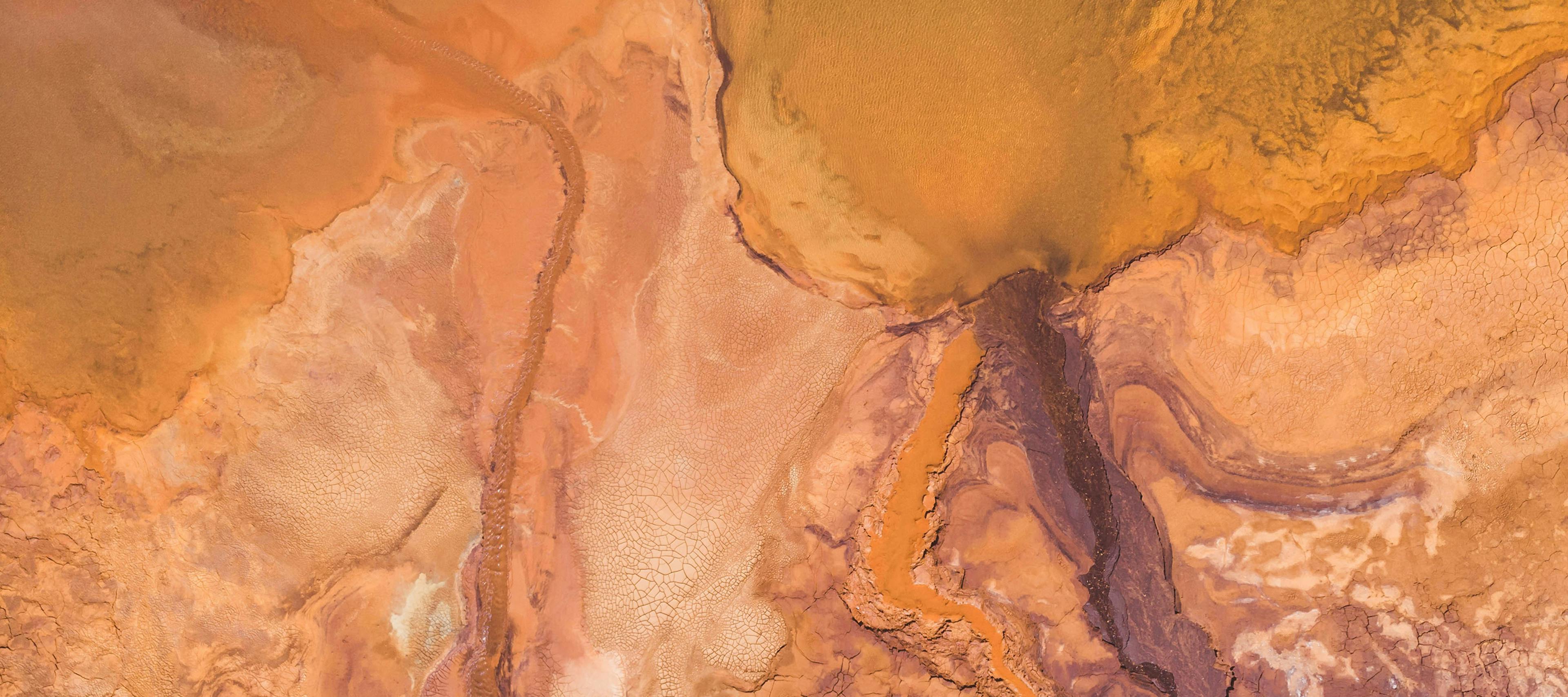 Aerial view of abstract pink and orange land.