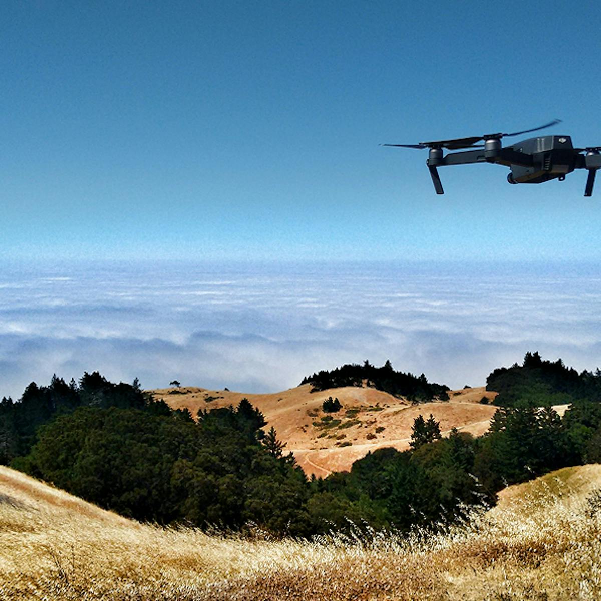 Drone flying over vast landscape.