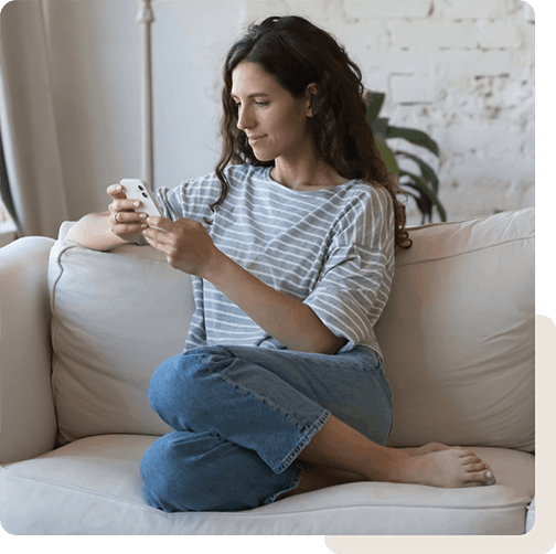 Lady on phone texting board-certified dermatologist