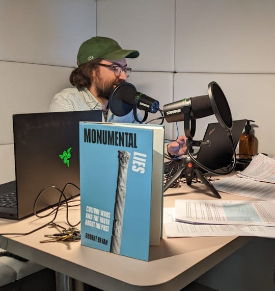 Image of two men recording a podcast