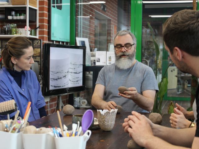 people moulding clay