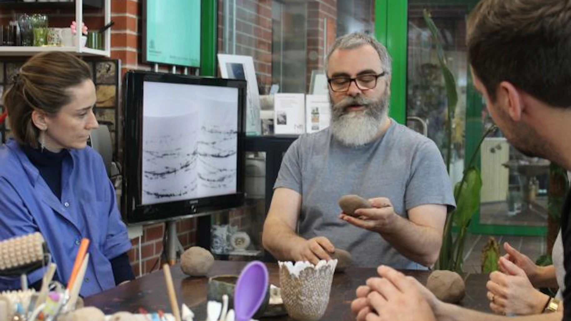 people moulding clay