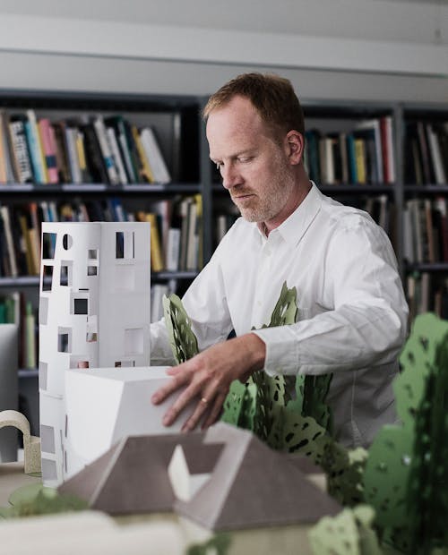 Image of David Kohn working on a model of a building