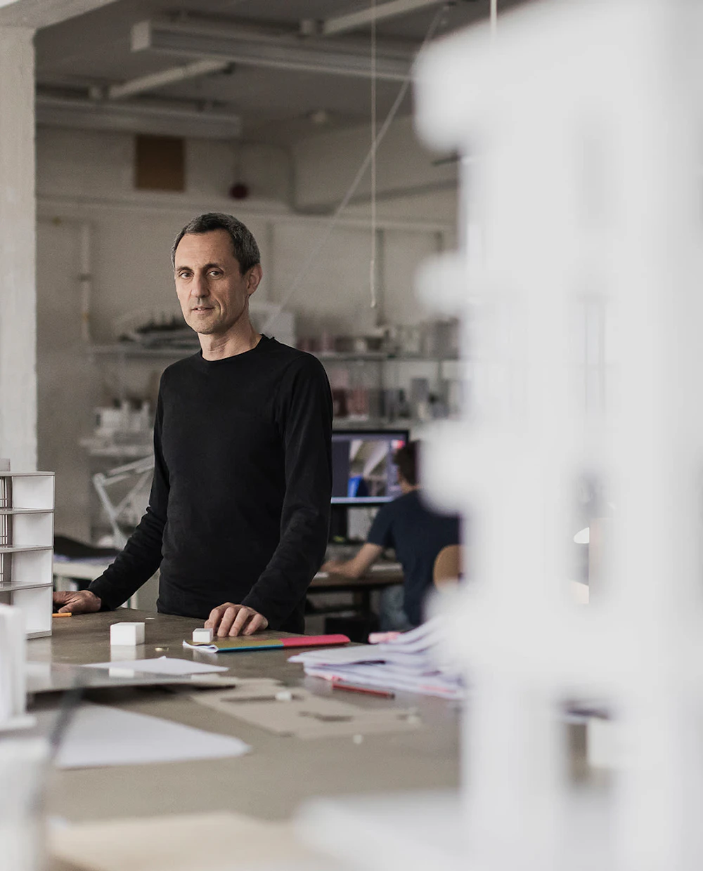 Image of a man standing at a desk