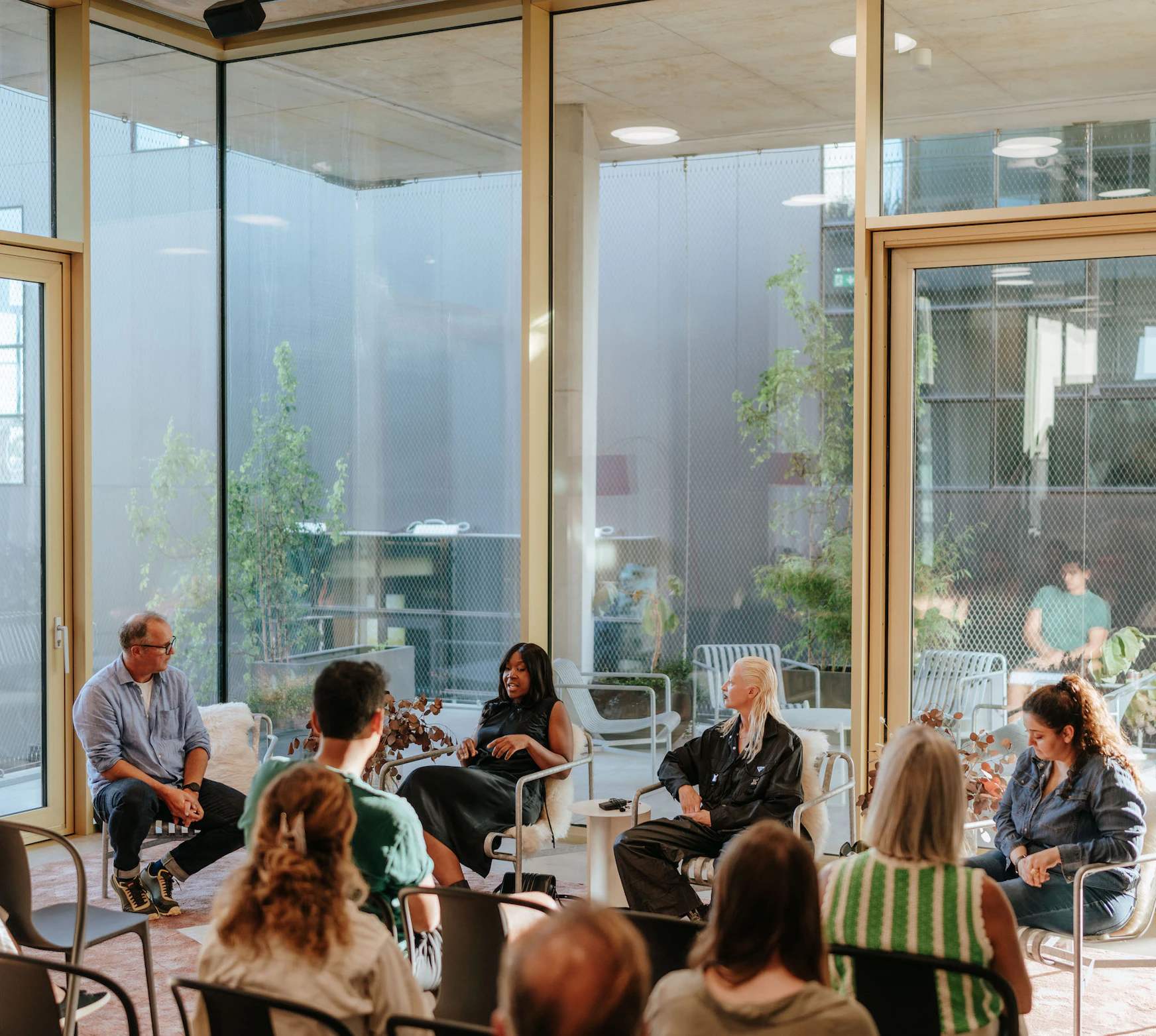 Image of a diverse group of people sitting and listening to a talk