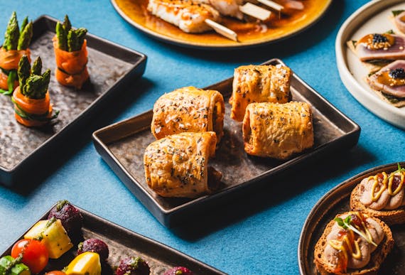 various canapes on a blue table with one in the centre