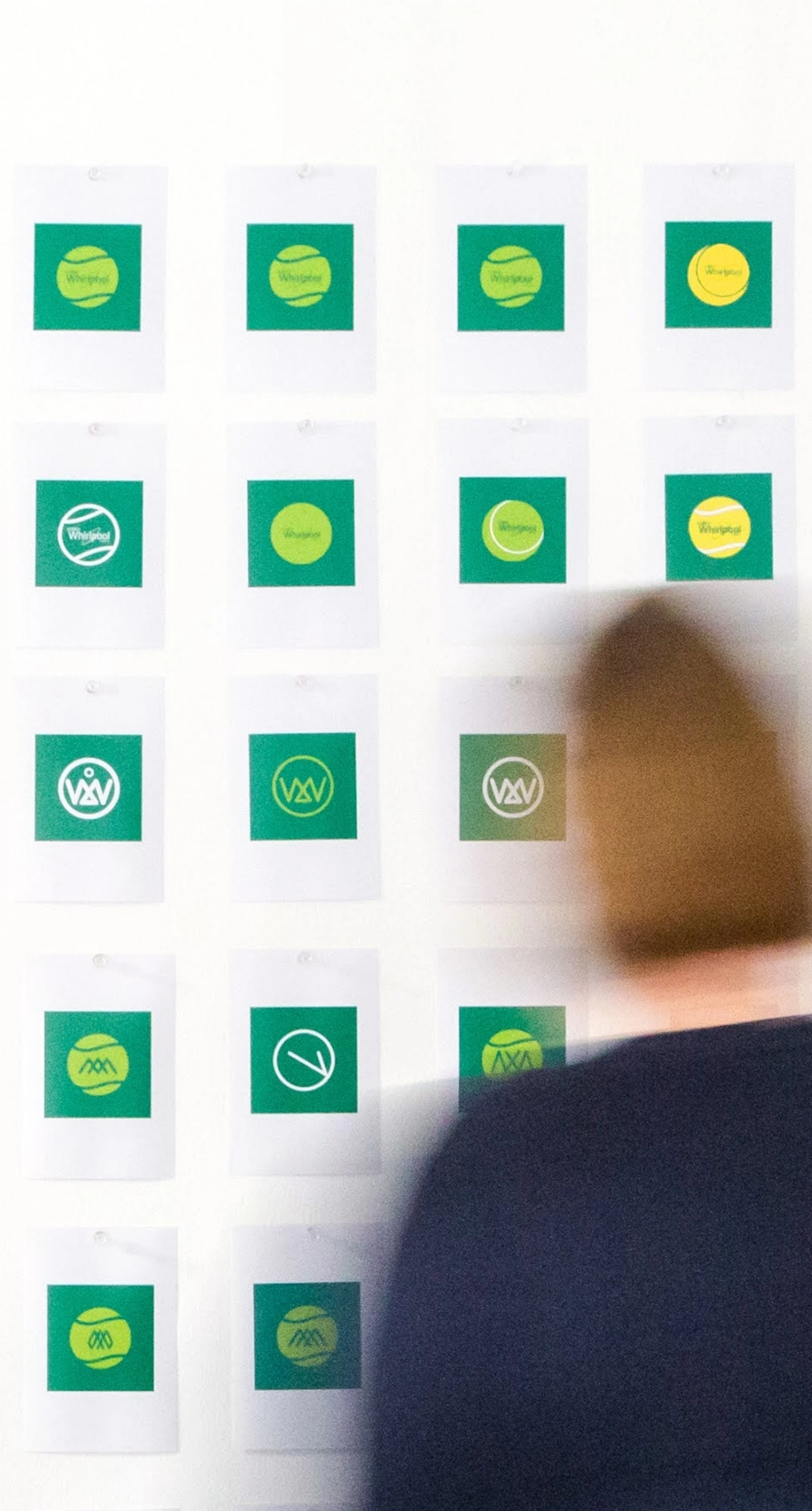 An image of a male and female looking at lots of different images on a wall