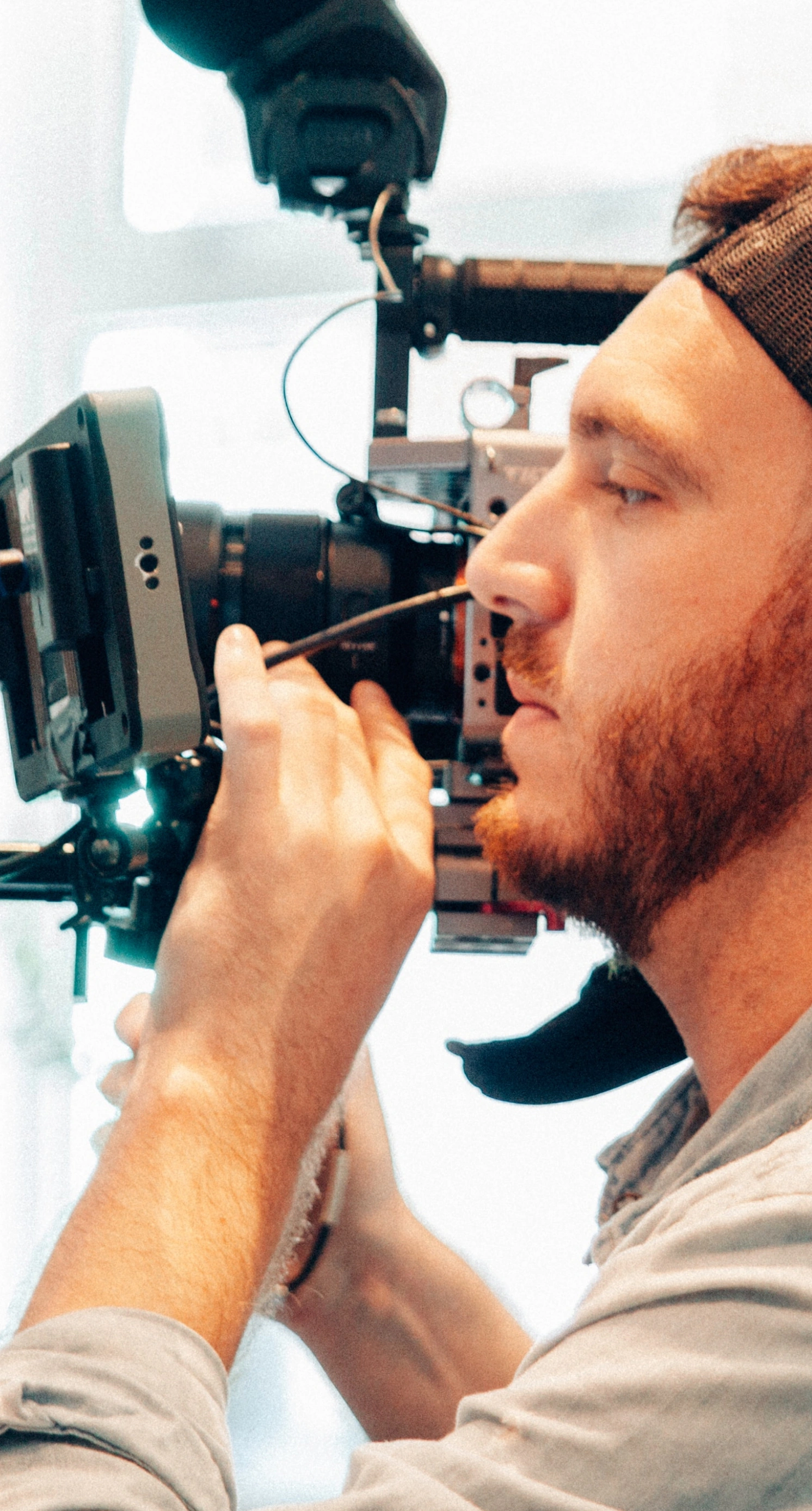 An image of a videographer recording footage on a shoot