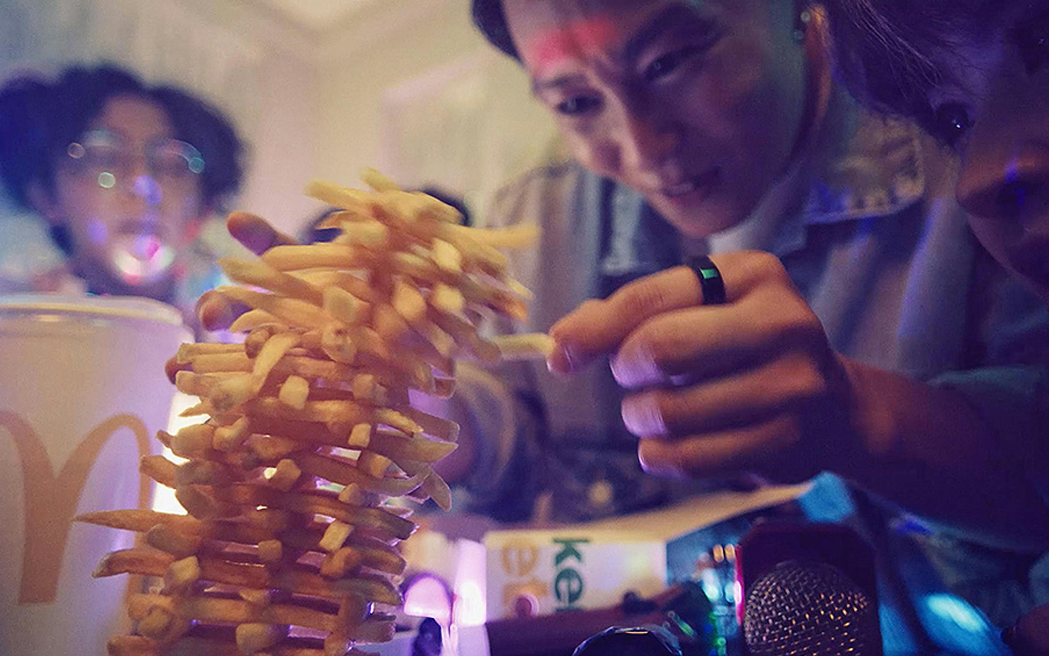 Someone balancing McDonalds fries