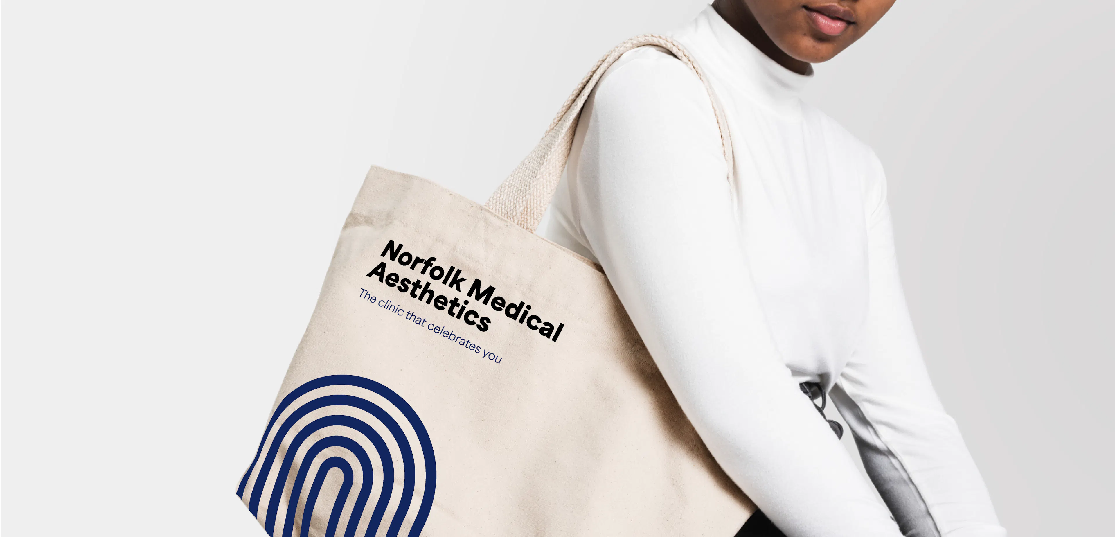 Woman wearing a branded tote bag