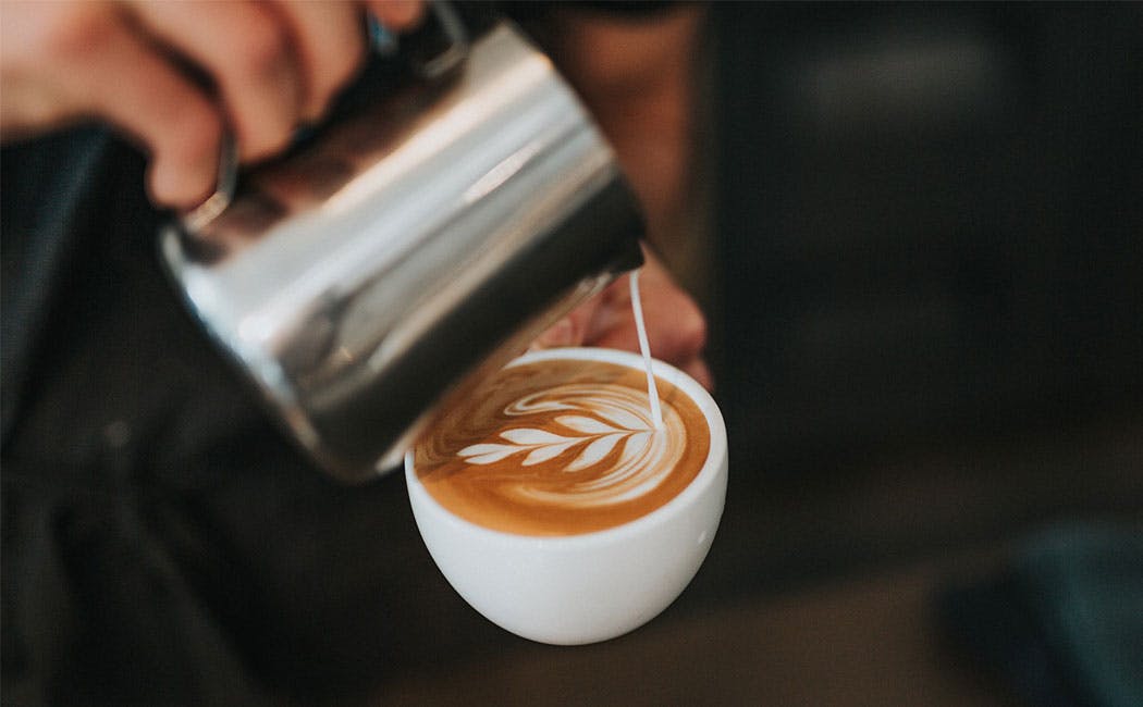 barista pouring coffee