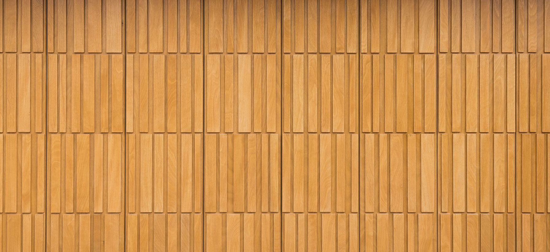 Close-up of a wooden garage door with a pattern.