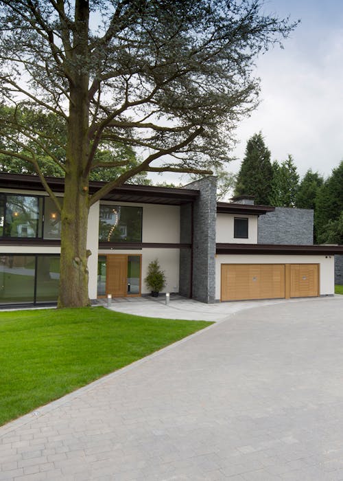 exterior of modern house with bespoke wooden front and garage doors