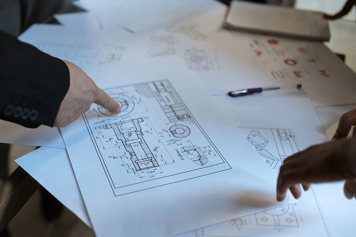 Building professionals studying technical drawings.