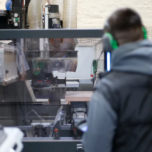 man using machinery to craft luxury doors