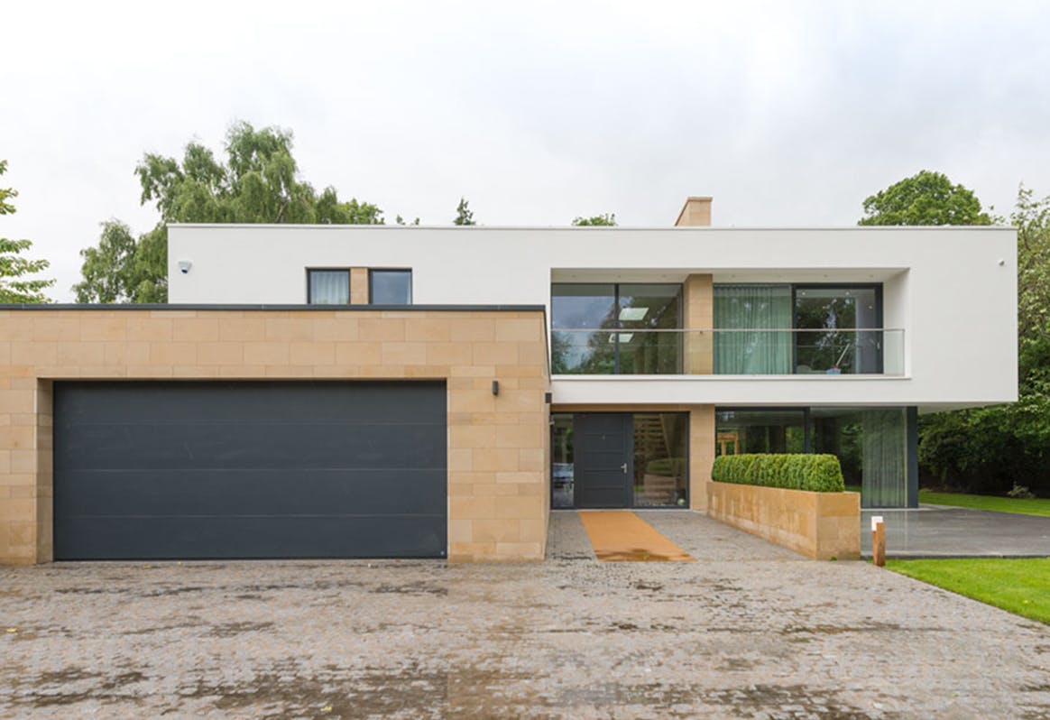 exterior of modern rectangular house with bespoke Olivo SI front and garage doors