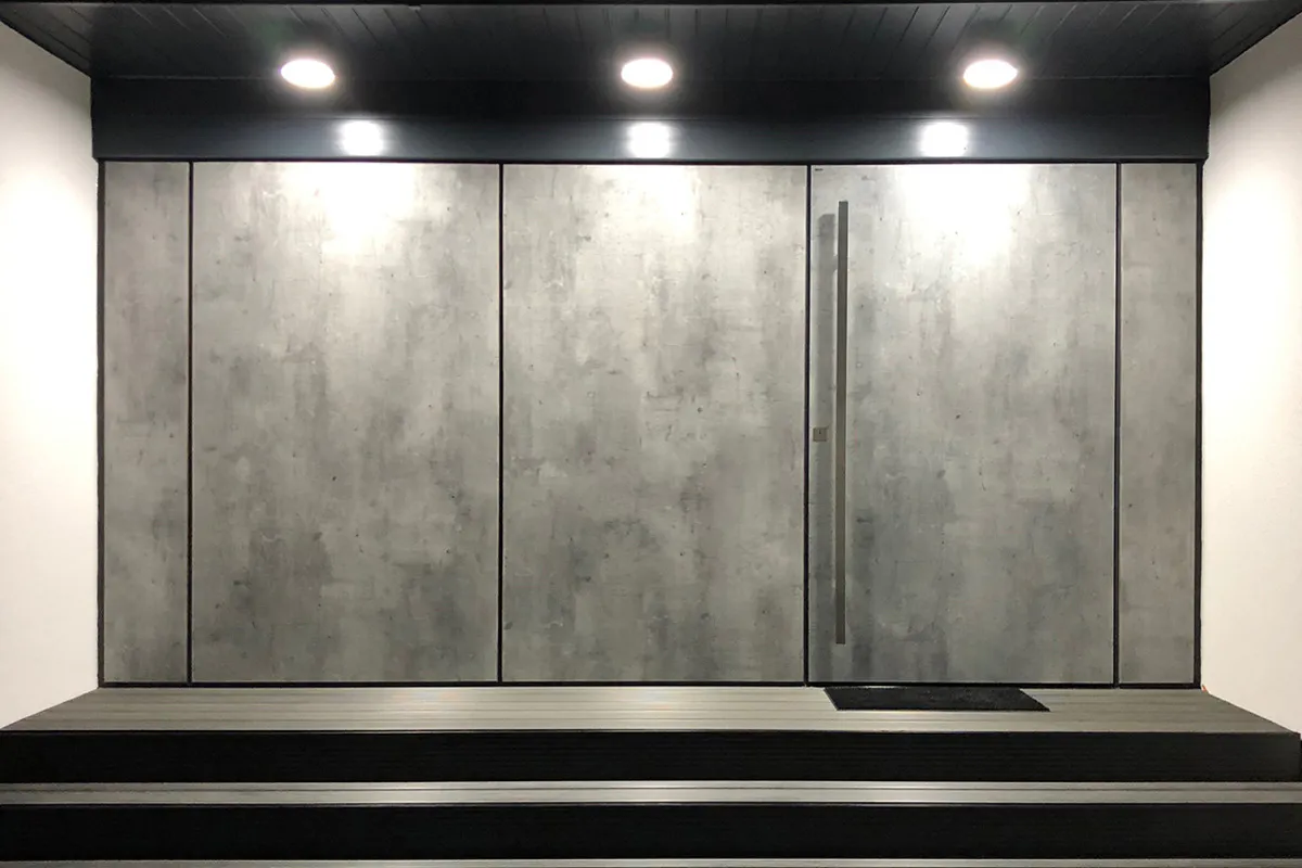 contemporary concrete look home entrance. Front door and surrounding cladding in Olivio style by Deuren