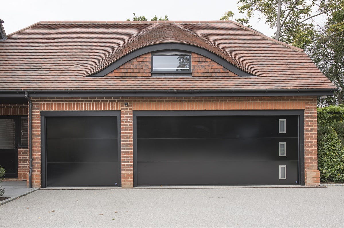 Bespoke glossy black garage doors with windows