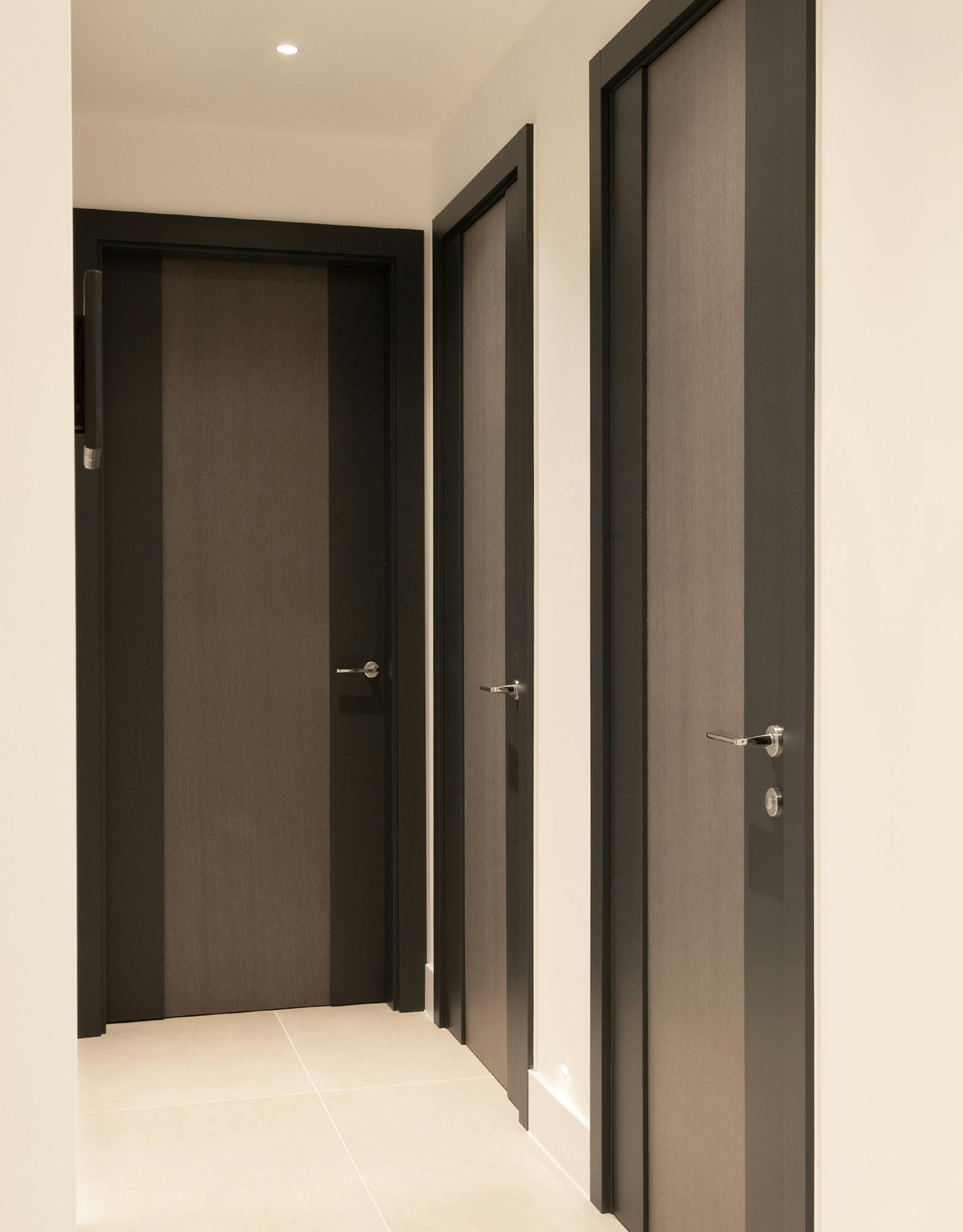 Contemporary corridor, with three Deuren made-to-measure internal doors - Linea style and dark grey painted finish.