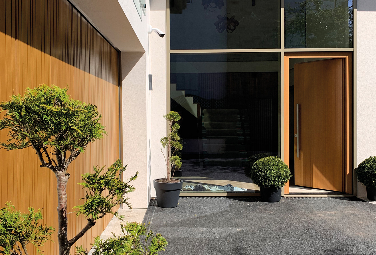 A modern house with matching wooden front and garage doors