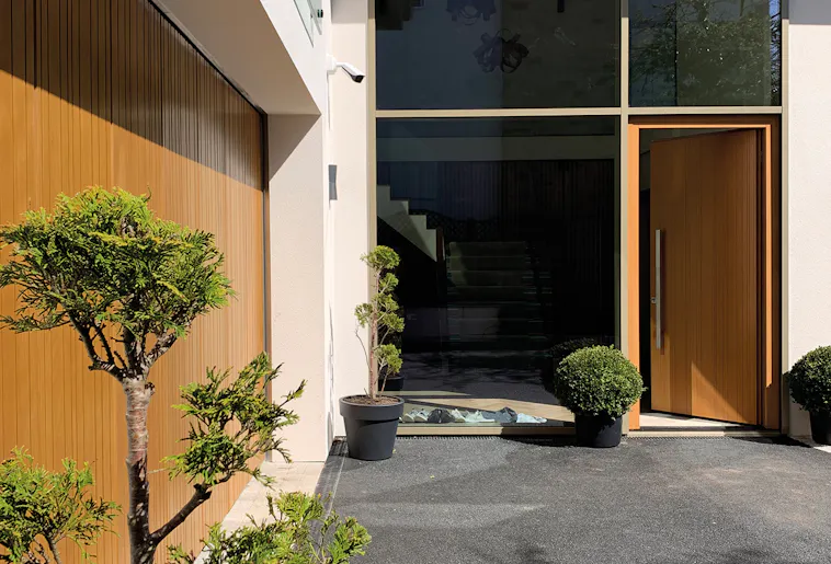 A modern house with matching wooden front and garage doors