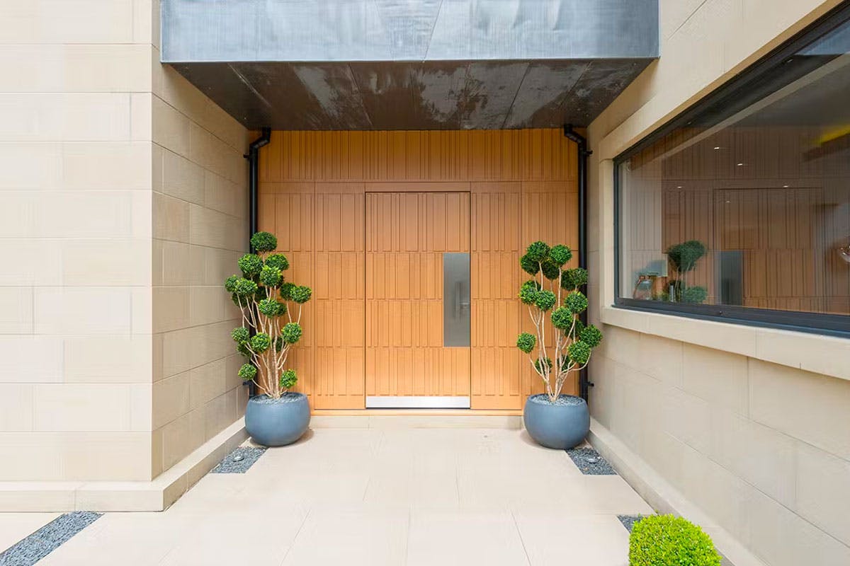 Contemporary home entrance with bespoke front door by Deuren - Door and and wall surround are in matched Tavole style, in honey oak finish. 