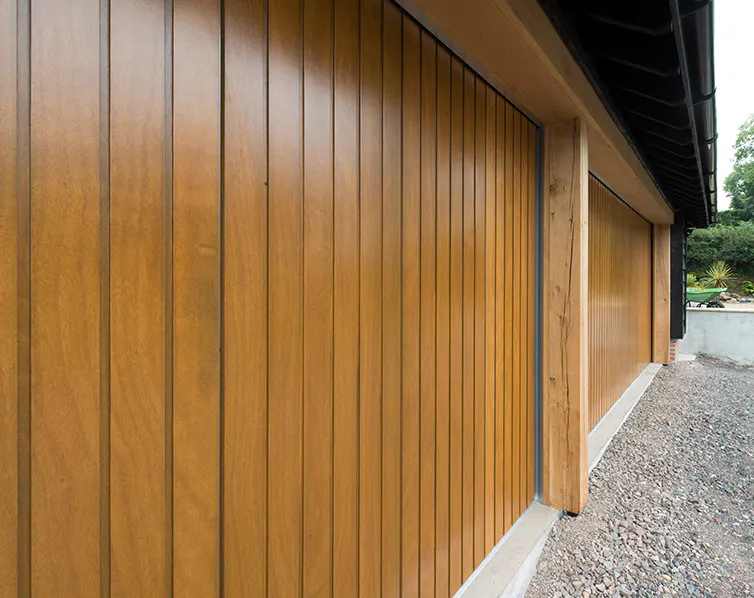 Close-up of a brown wooden garage door with a vertical wood grain.
