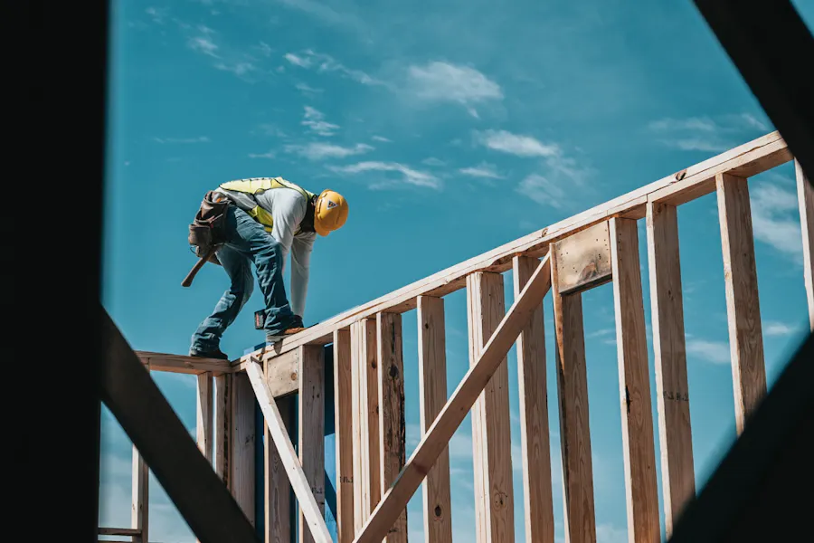 A construction worker on the frame of a house