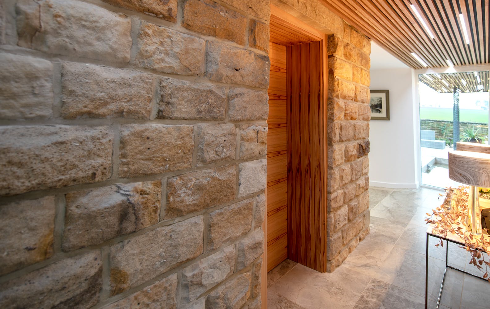 A contemporary meets Yorkshire stone hallway, featuring made-to-measure internal door set with extra deep frames demonstrates Deuren's made-to-measure door set capabilities perfect for period properties.