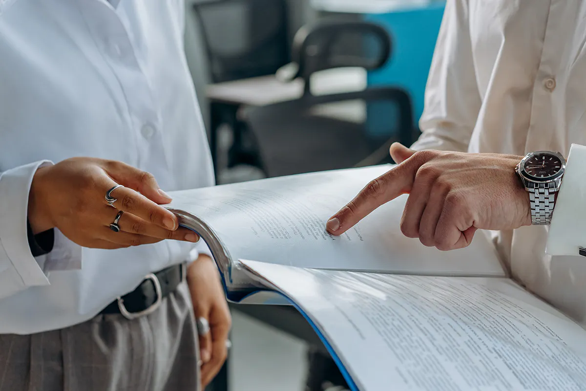 Two professionals studying notes.