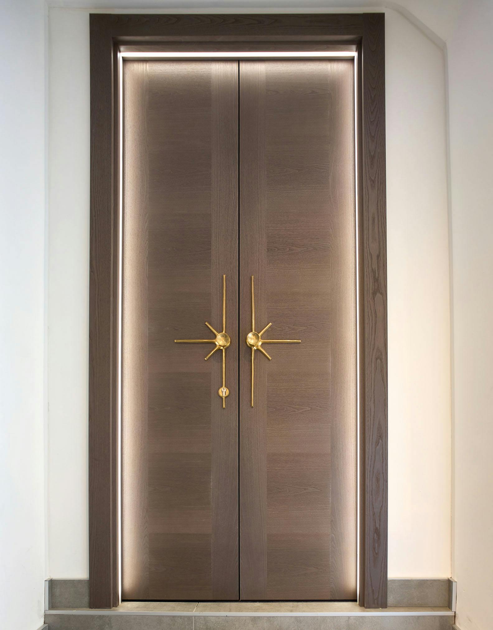Bespoke double door set with LED lighting set within the door frame that wraps around and illuminates the doors.