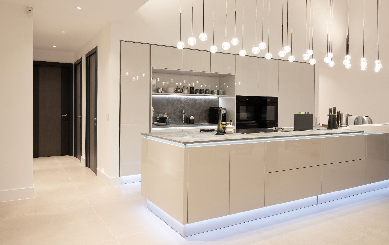 A highly sophisticated kitchen and side corridor with three Deuren made-to-measure internal door sets -  - Linea style and dark grey painted finish.
