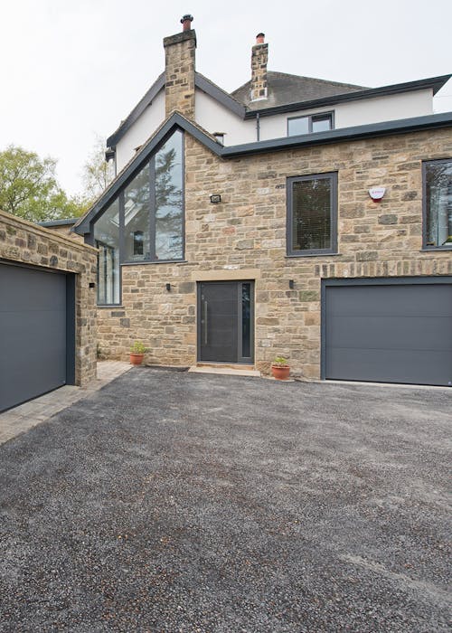 exterior of large house with bespoke Olivo SI front and garage doors