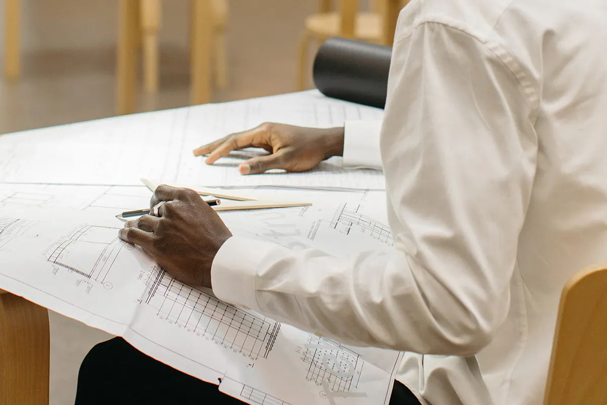 a professional working on some technical drawings