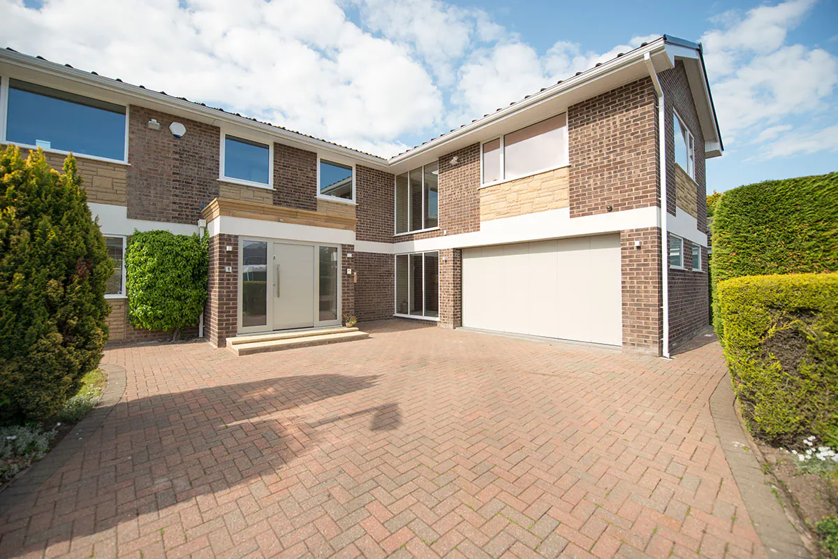 house exterior with modern matching front and garage doors